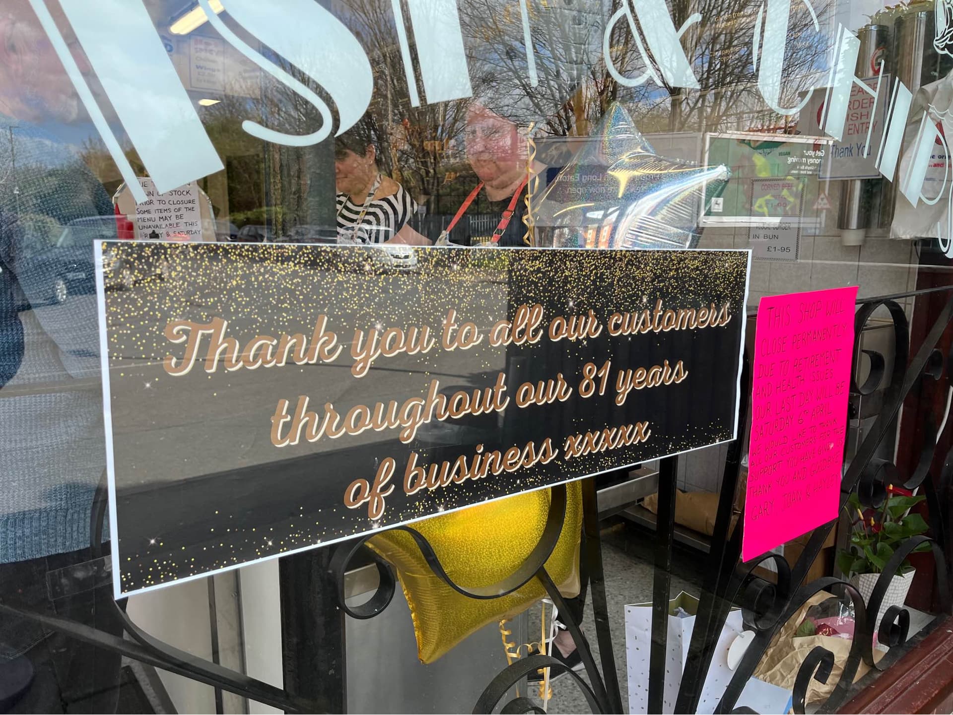 A banner placed on the glass window, stating 'Thank you to all our customers throughout our 81 years of business xxxxx'.